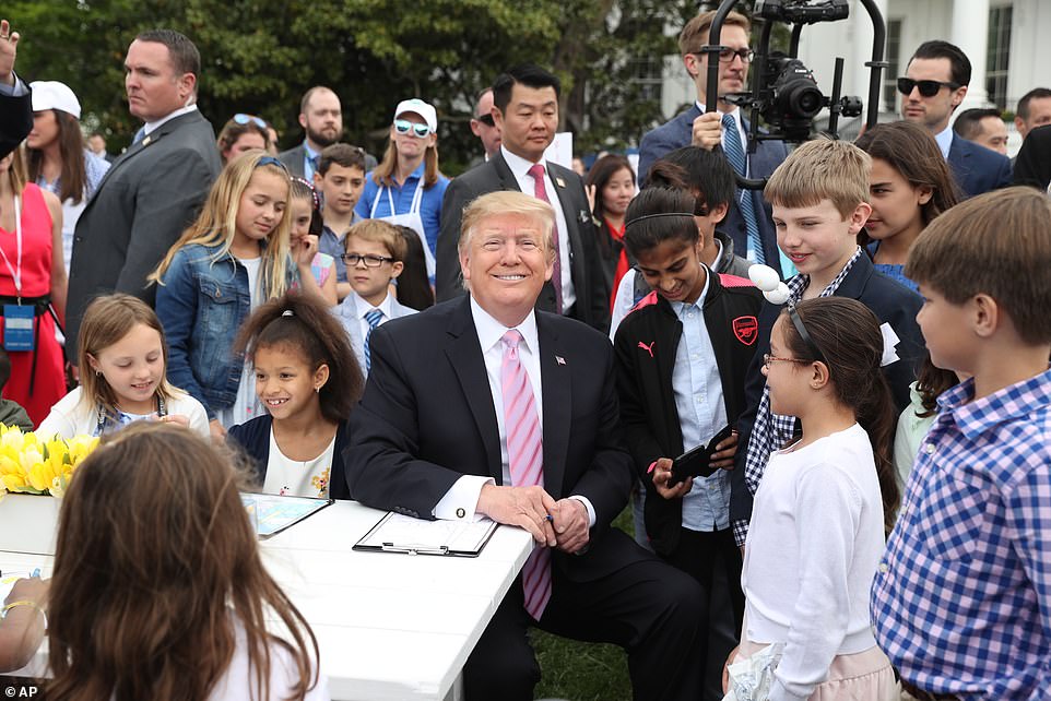 12578532-6947099-President_Trump_poses_with_the_kids_at_the_postcard_table-a-75_1555955035434