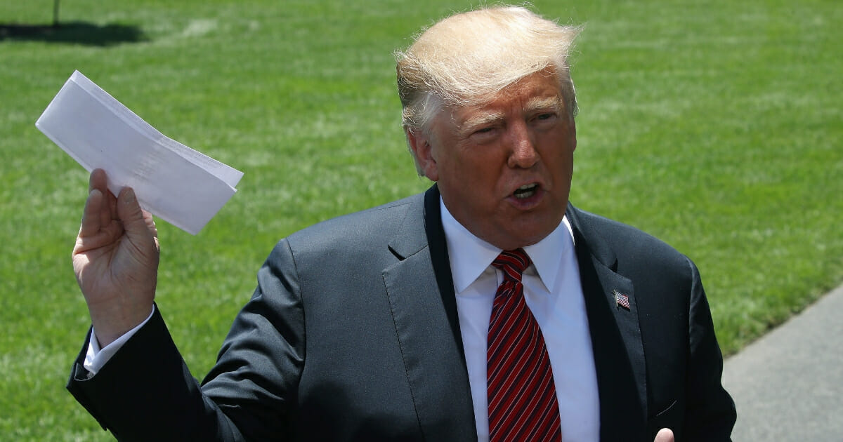 Donald-Trump-waving-copy-of-Mexico-deal